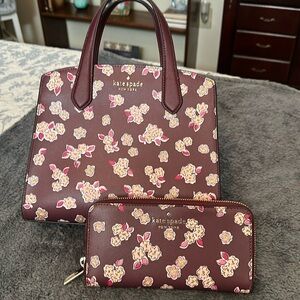 The color is more burgundy with tiny roses and slight sparkle. Strap/crossbody